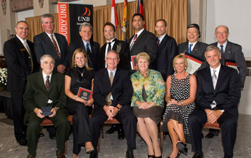 Seated at the awards dinner, from left, are 2009 Proudly UNB Awards recipients <b>Theodore Bremner, Emily Black, Peter McGill, Barbara McGill, Mary Duffley</b> and <b>John Wallace.</b> Standing, from left, Association President <b>Larry Hachey,</b> and award recipients <b>Steve McGill, Gérard La Forest, Jason MacLean, Jesse Simon, Robert Quartermain, Jsun Wong</b>, and <b>Wayne Jollineau.</b>