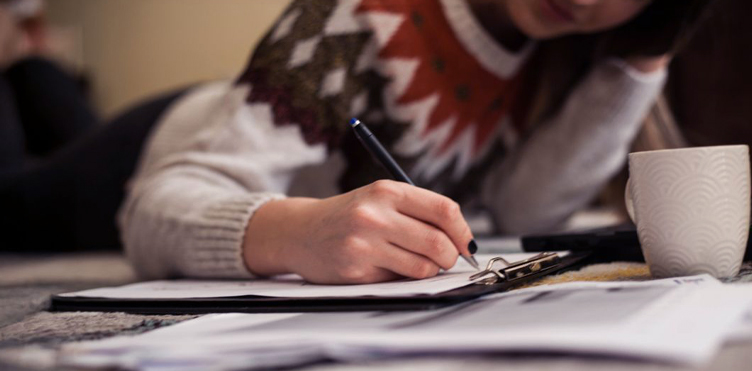 Student writing in a notepad