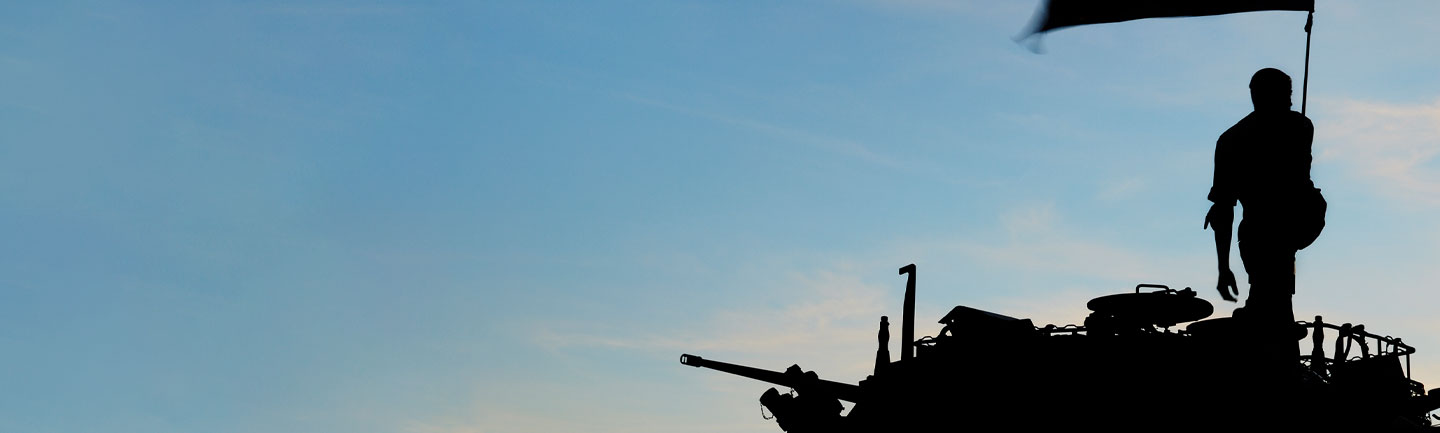 Silouette of military personnel on a tank
