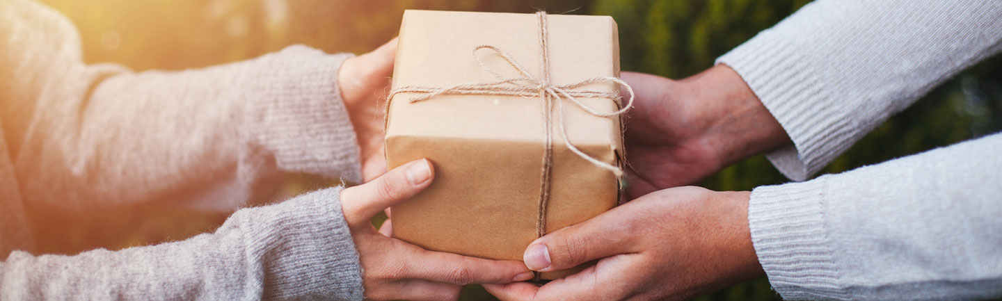 A person giving a gift to another person