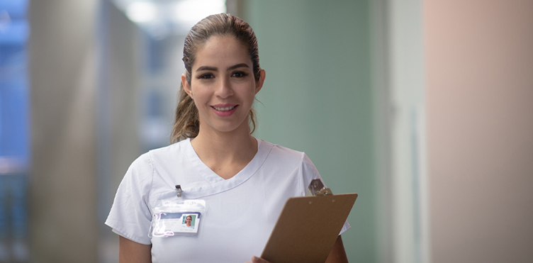 Smiling nurse in white scrubs
