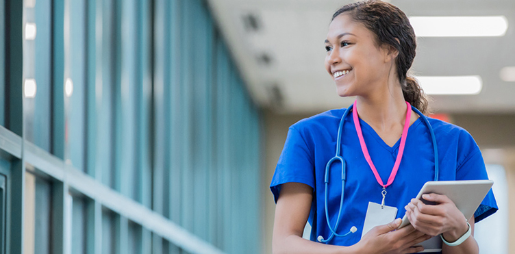 Smiling nurse in blue scrubs