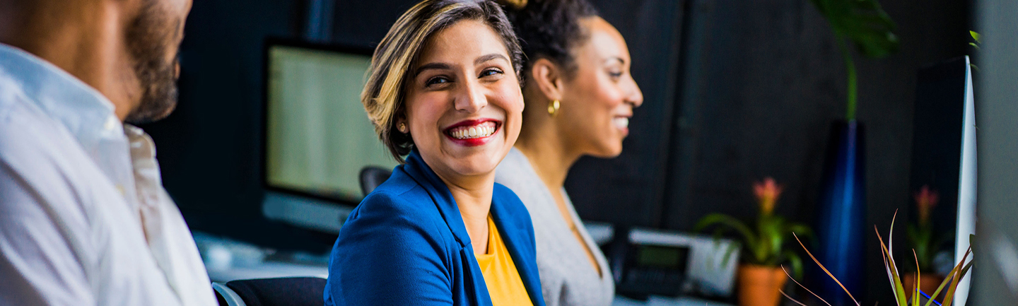 Photograph of a professional in a blue jacket smiling